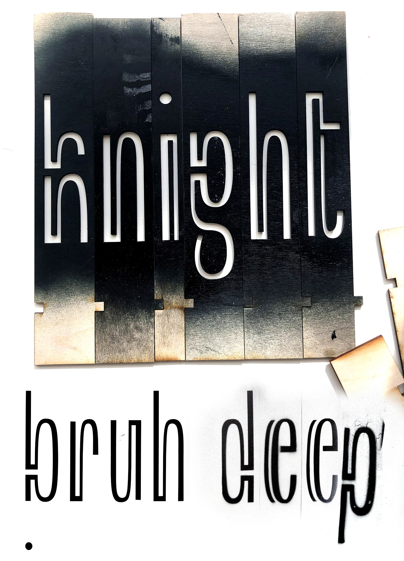 Image of designed type, used digitally, cut out of wood and spraypainted use.